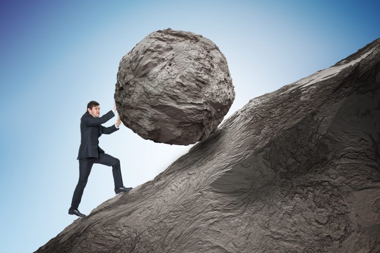 sisyphus-metaphore-young-businessman-pushing-heavy-stone-boulder-up-on